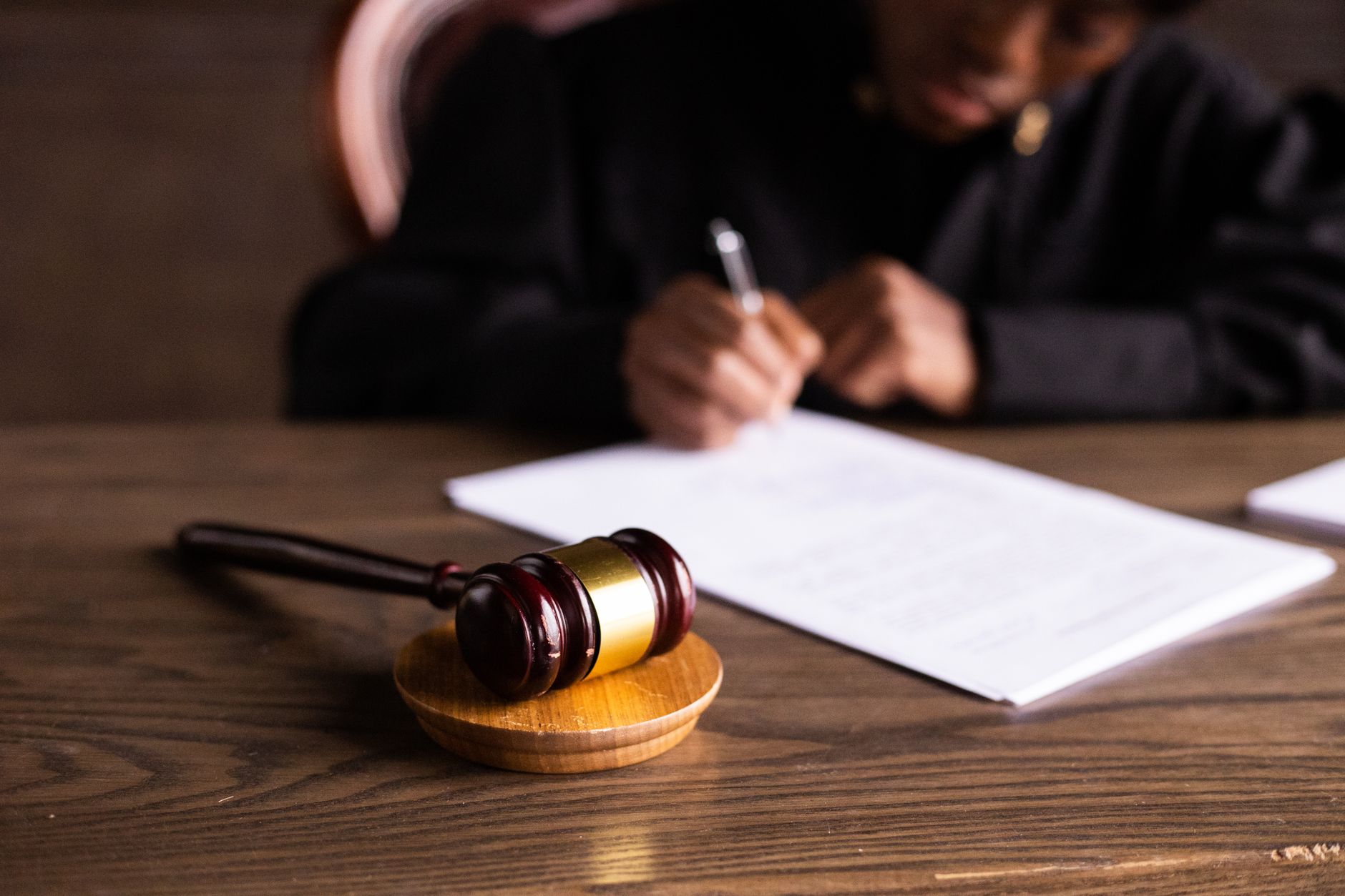 Law book and gavel on a wooden desk, symbol of legal terms
