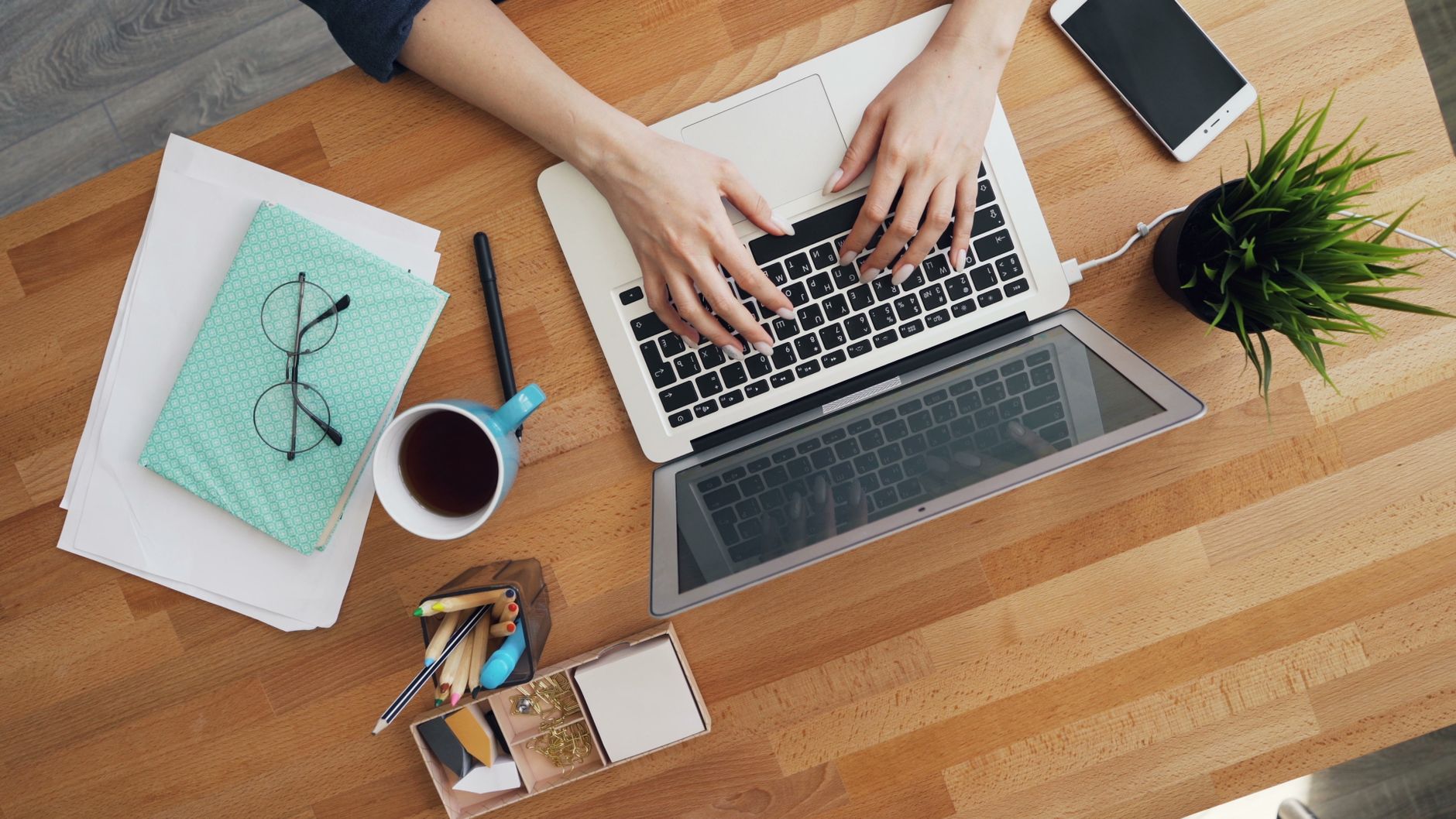 Person typing on a laptop at a desk